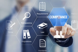 Compliance concept with icons for regulations, law, standards, requirements and audit on a virtual screen with a business person touching a button